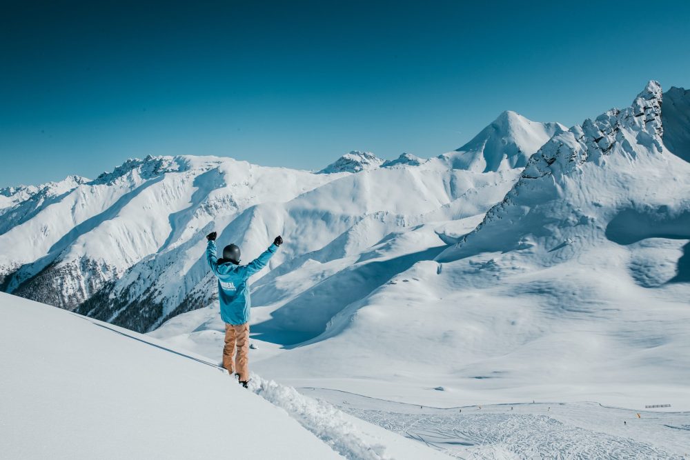 גולש באתר הסקי אישגל צופה בהרים מושלגים